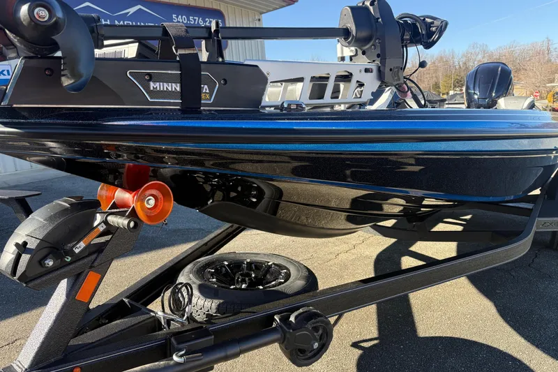 Slide: The Image of 2026 Skeeter ZXE21 boat on trailer with Minn Kota motor, outdoor setting. - 6