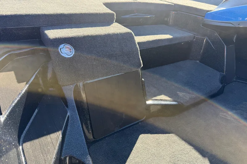 Slide: The Image of Interior of 2026 Skeeter ZXE21 boat with carpeted seating and storage compartments. - 8