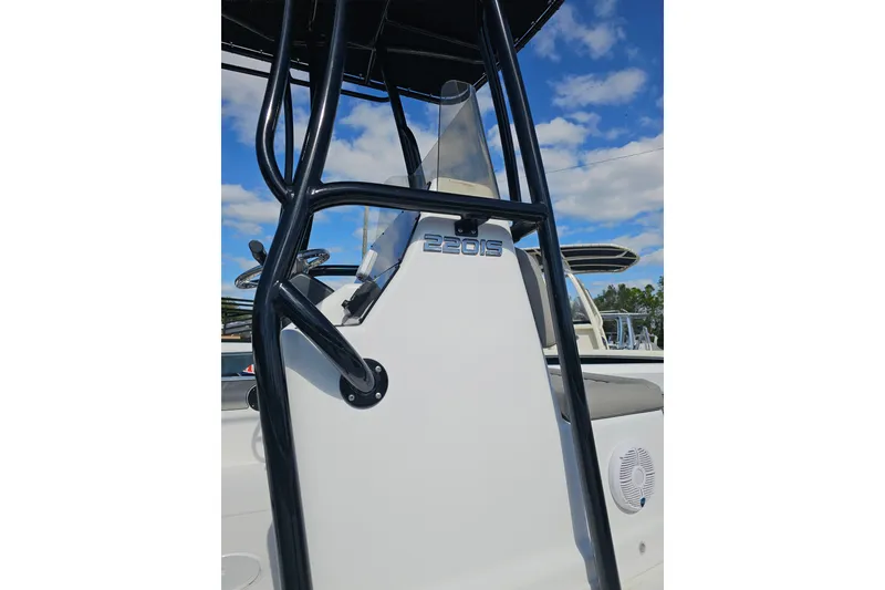 Slide: The Image of 2025 Savannah 220 IS boat console with black frame against blue sky. - 5