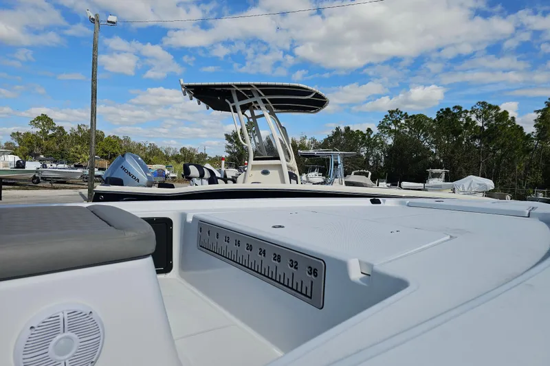 Slide: The Image of 2025 Savannah 220 IS boat with seating and measurement scale, under a blue sky. - 6