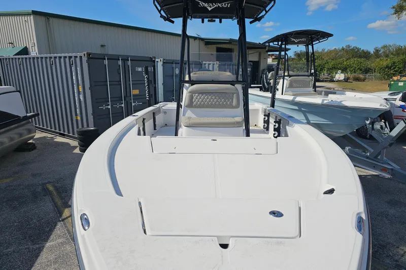 Slide: The Image of 2025 Savannah 220 IS boat displayed outdoors, featuring sleek design and modern seating. - 8
