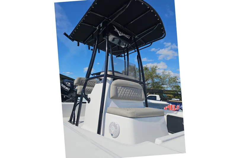 Slide: The Image of 2025 Savannah 220 IS boat with T-top and seating, under a clear blue sky. - 9