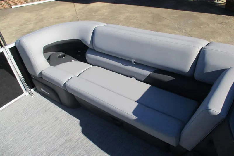 Slide: The Image of 2026 Sun Tracker Party Barge 20 DLX with comfortable gray seating and cup holders. - 8