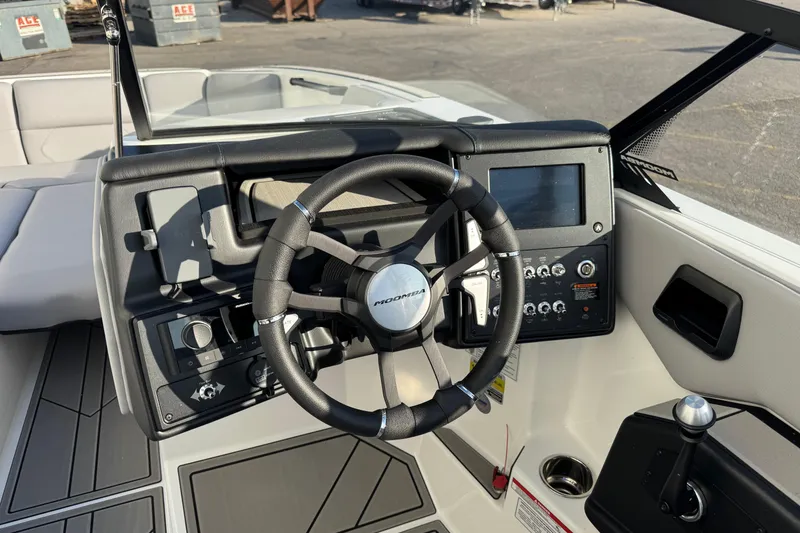 Slide: The Image of 2026 Moomba Tykon boat dashboard with steering wheel and control panel. - 11