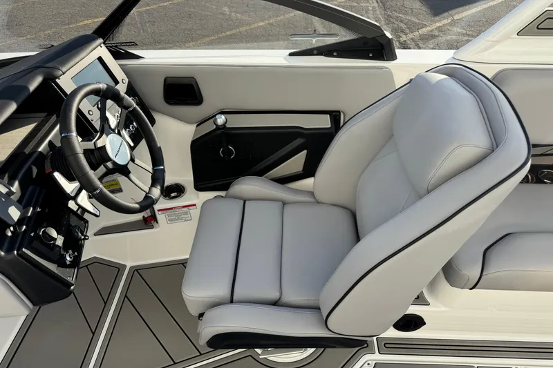 Slide: The Image of 2026 Moomba Tykon boat interior with steering wheel and plush seating. - 12