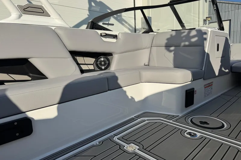 Slide: The Image of 2026 Moomba Tykon boat interior with gray seating and modern design elements. - 13
