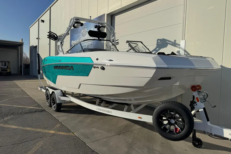 Slide: The Image of 2026 Moomba Tykon boat on trailer, parked outside a building. - 5