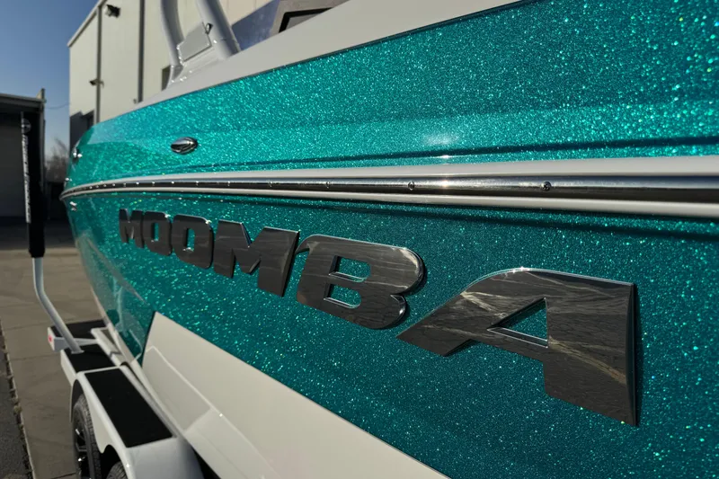Slide: The Image of 2026 Moomba Tykon boat with sparkling teal finish on a trailer. - 7