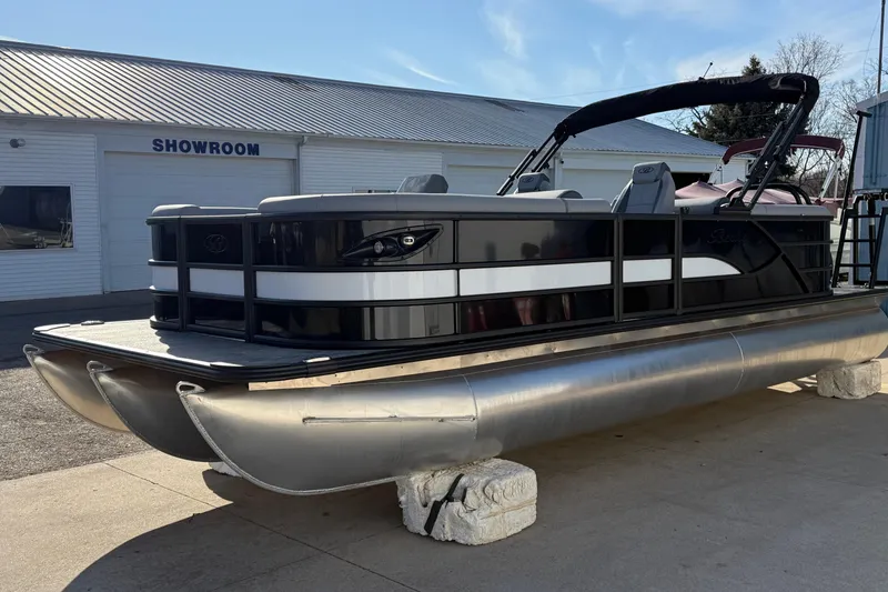 Slide: The Image of 2026 Bentley Pontoons Legacy 243 Navigator displayed outside a showroom. - 3