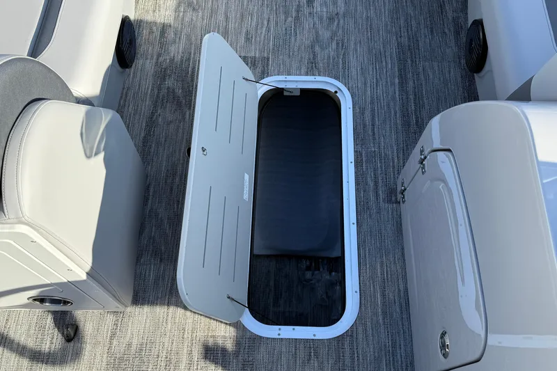 Slide: The Image of 2026 Bentley Pontoons Legacy 243 Navigator interior storage compartment open on deck. - 33