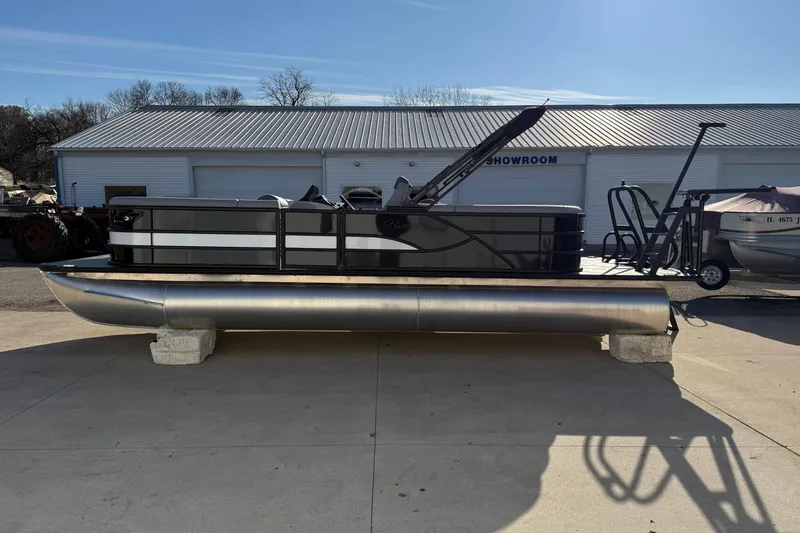 Slide: The Image of 2026 Bentley Pontoons Legacy 243 Navigator displayed outdoors on concrete blocks. - 4