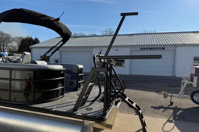 Slide: The Image of 2026 Bentley Pontoons Legacy 243 Navigator in front of a showroom building. - 5