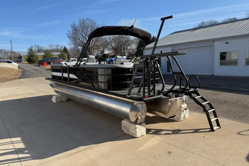 Slide: The Image of 2026 Bentley Pontoons Legacy 243 Navigator on display outside a showroom. - 6