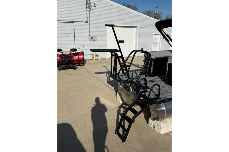 Slide: The Image of 2026 Bentley Pontoons Legacy 243 Navigator with ladder and railing, parked outdoors. - 9