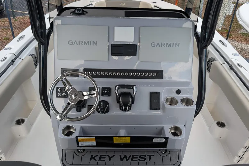 Slide: The Image of 2026 Key West 291 FS boat dashboard with Garmin navigation systems and steering wheel. - 17