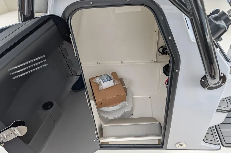 Slide: The Image of 2026 Key West 291 FS boat interior storage compartment with open door and visible items. - 18