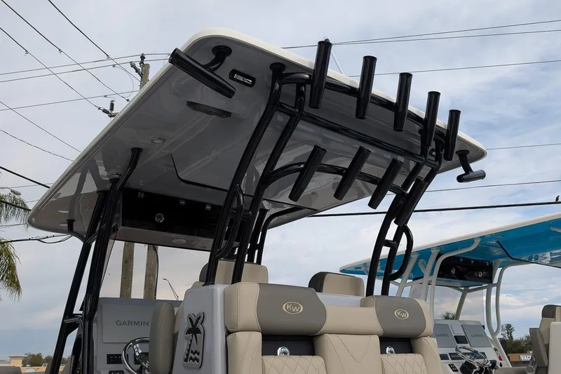 Slide: The Image of 2026 Key West 291 FS boat with T-top and rod holders, featuring Garmin electronics. - 23