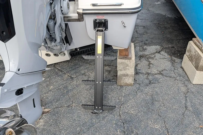 Slide: The Image of Rear view of 2026 Key West 291 FS boat with motor and ladder on concrete blocks. - 6