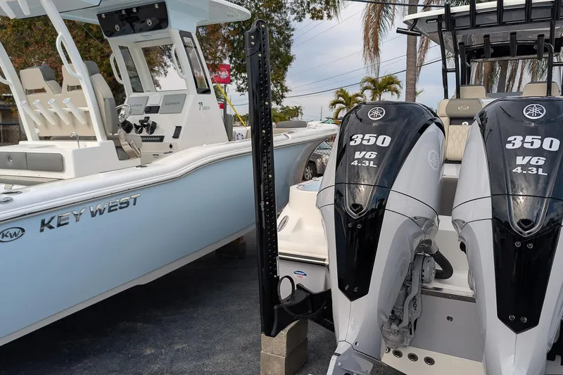 Slide: The Image of 2026 Key West 291 FS boat with twin 350 V6 engines, parked outdoors. - 7