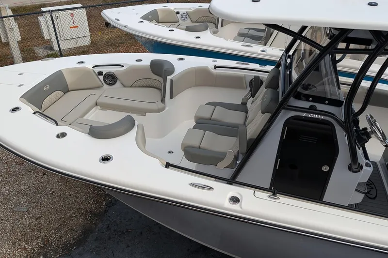 Slide: The Image of 2026 Key West 291 FS boat interior with seating and console, docked outdoors. - 9