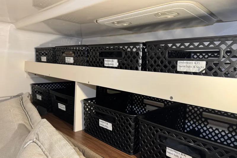 Slide: The Image of Storage baskets in a 2022 Boston Whaler 325 Conquest Pilothouse cabin. - 14