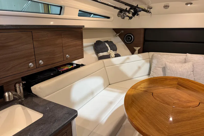 Slide: The Image of Luxurious interior of 2022 Boston Whaler 325 Conquest Pilothouse with wood accents and plush seating. - 17