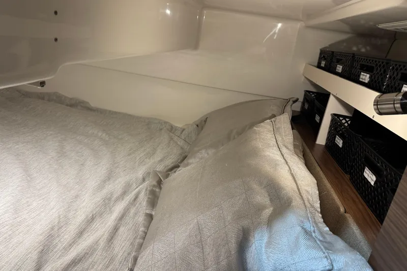 Slide: The Image of Interior cabin of 2022 Boston Whaler 325 Conquest Pilothouse with bedding and storage baskets. - 19