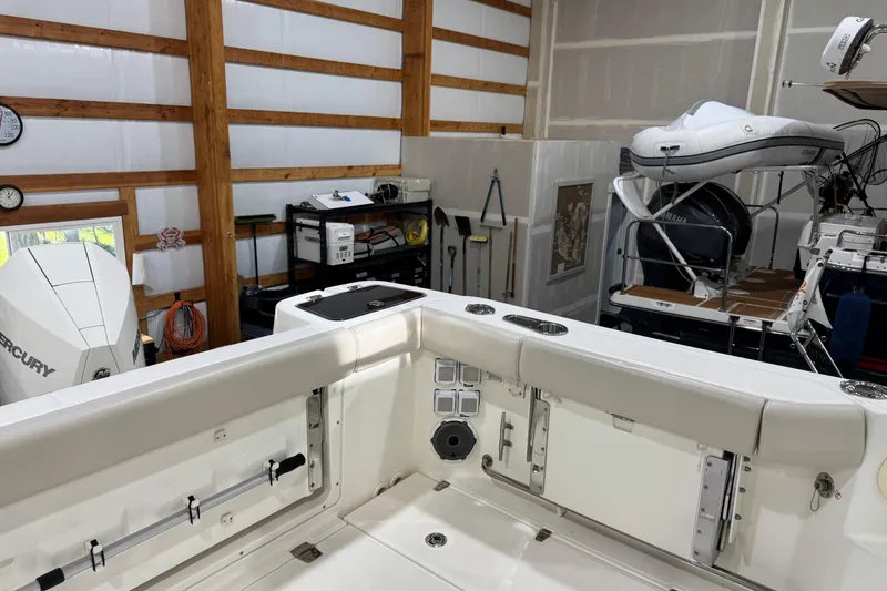 Slide: The Image of 2022 Boston Whaler 325 Conquest Pilothouse in a well-equipped indoor storage facility. - 3