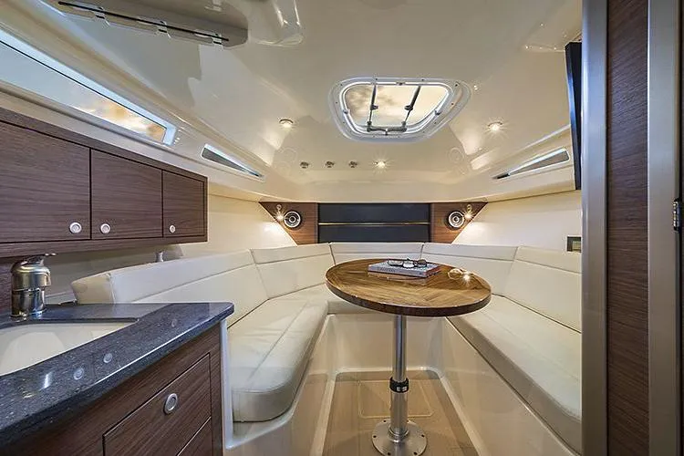 Slide: The Image of Manufacturer Provided Image: Interior of 2022 Boston Whaler 325 Conquest Pilothouse with seating and table. - 6