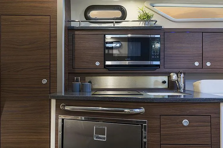 Slide: The Image of Manufacturer Provided Image: Modern kitchen area in 2022 Boston Whaler 325 Conquest Pilothouse boat. - 7