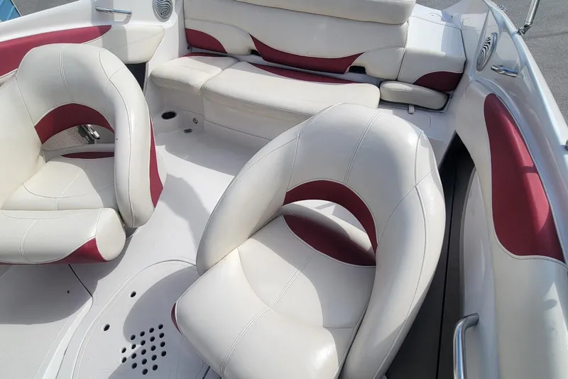 Slide: The Image of 2014 Tahoe Q7i boat interior with white and red cushioned seating. - 11