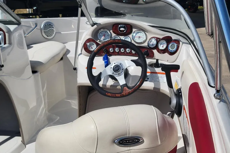 Slide: The Image of Interior of a 2014 Tahoe Q7i boat with steering wheel and dashboard controls. - 13