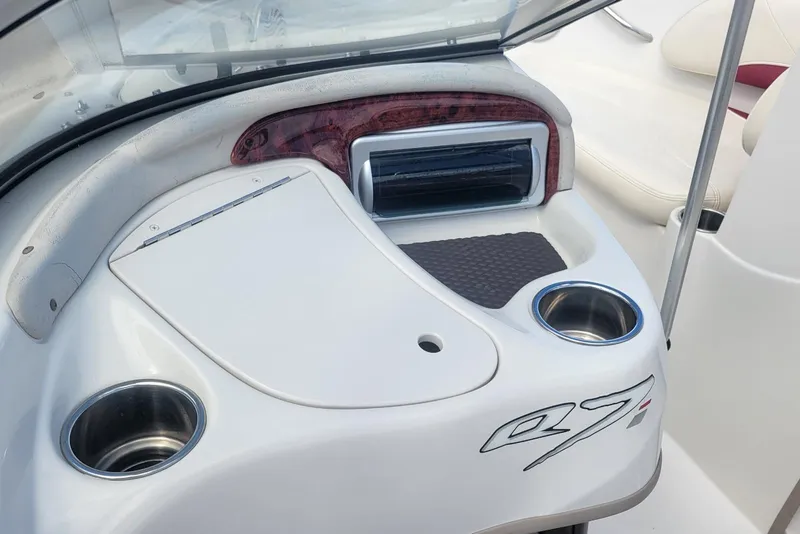 Slide: The Image of 2014 Tahoe Q7i boat dashboard with cup holders and storage compartment. - 15