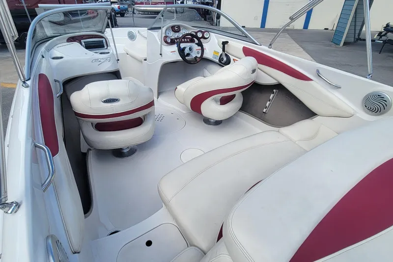 Slide: The Image of 2014 Tahoe Q7i boat interior with white and red seating, steering wheel, and dashboard. - 16