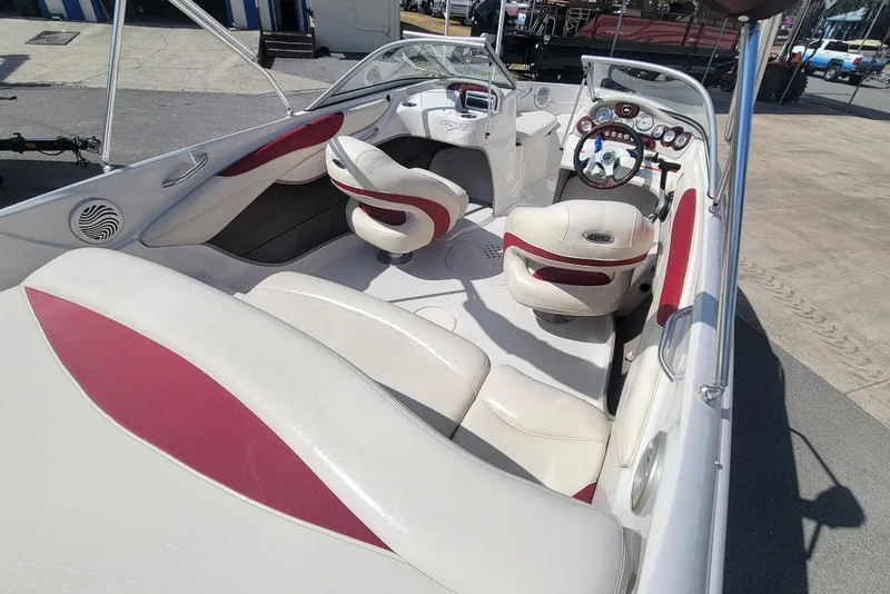 Slide: The Image of 2014 Tahoe Q7i boat interior with white and red seating, steering wheel, and dashboard. - 17