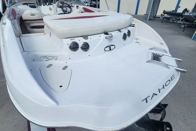 Slide: The Image of 2014 Tahoe Q7i boat with white and red interior, docked outdoors. - 20