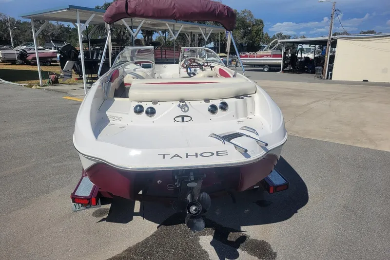 Slide: The Image of 2014 Tahoe Q7i boat with maroon accents parked on a trailer. - 4