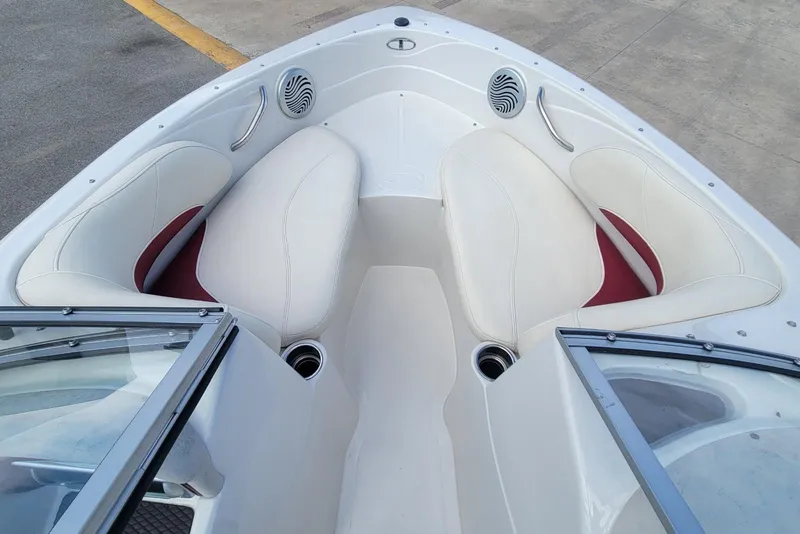 Slide: The Image of 2014 Tahoe Q7i boat interior with white and red seating, cup holders, and speakers. - 7