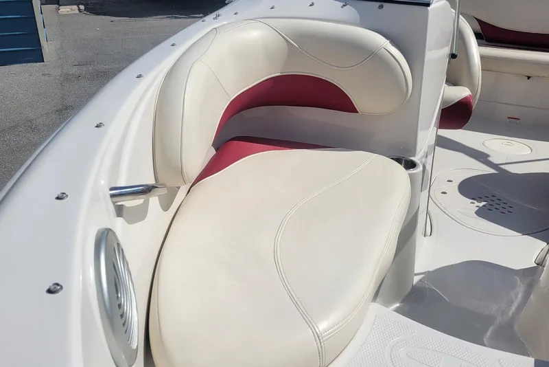 Slide: The Image of 2014 Tahoe Q7i boat interior with white and red cushioned seating. - 9