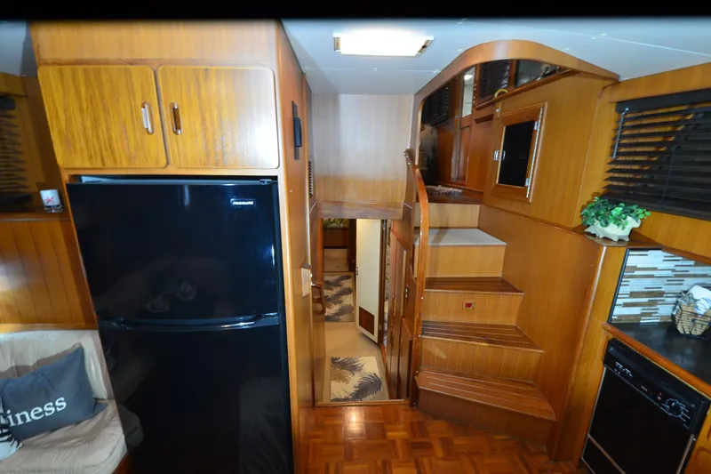 Slide: The Image of Interior of a 1990 Jefferson 52 Marquessa ED yacht with wooden cabinetry and modern appliances. - 18