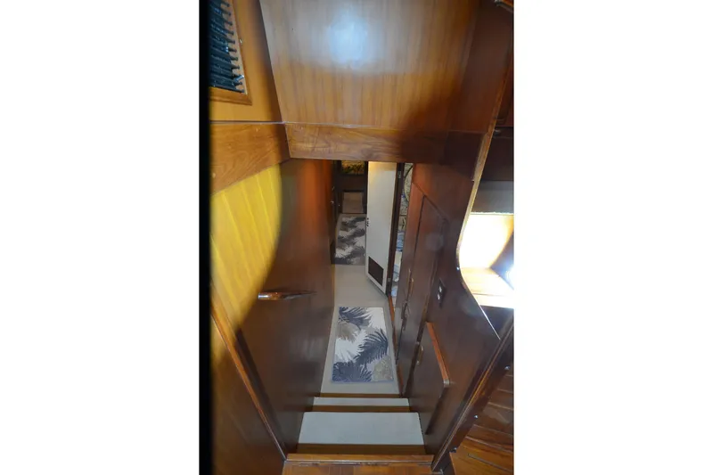 Slide: The Image of Interior view of 1990 Jefferson 52 Marquessa ED yacht with wooden paneling and carpeted stairs. - 19