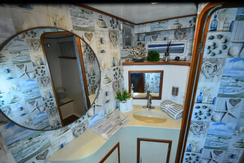 Slide: The Image of Nautical-themed bathroom in a 1990 Jefferson 52 Marquessa ED yacht, featuring decorative wallpaper. - 22