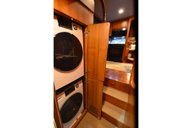 Slide: The Image of Laundry area inside 1990 Jefferson 52 Marquessa ED yacht with stacked washer and dryer. - 24