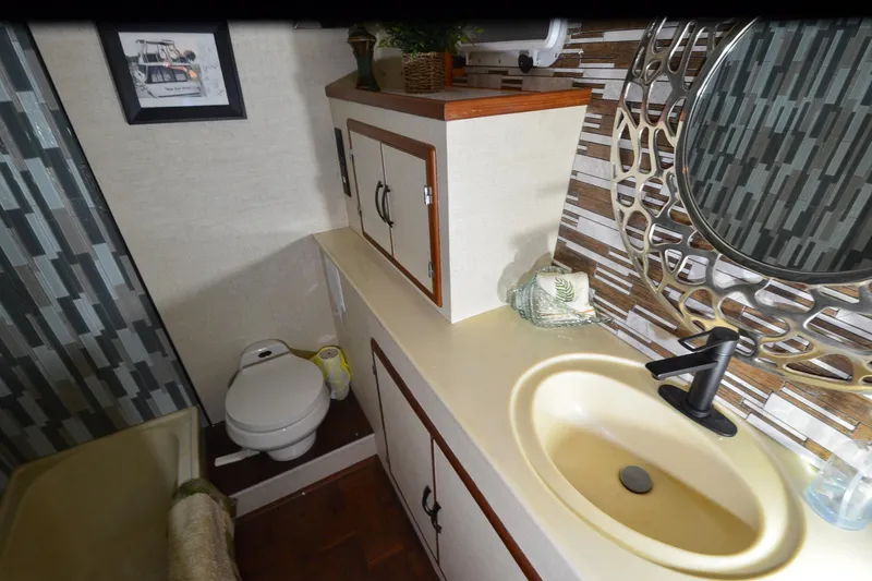 Slide: The Image of Bathroom interior of 1990 Jefferson 52 Marquessa ED yacht with modern sink and decorative mirror. - 27