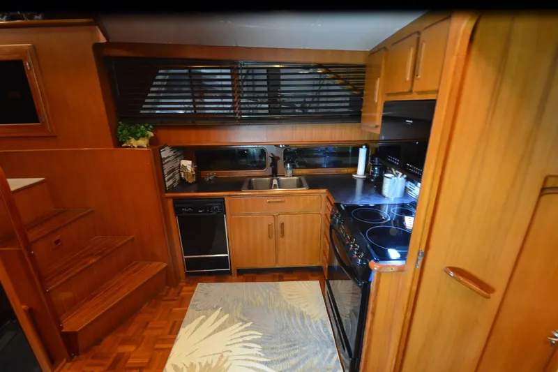 Slide: The Image of 1990 Jefferson 52 Marquessa ED yacht kitchen with wood cabinetry and modern appliances. - 33
