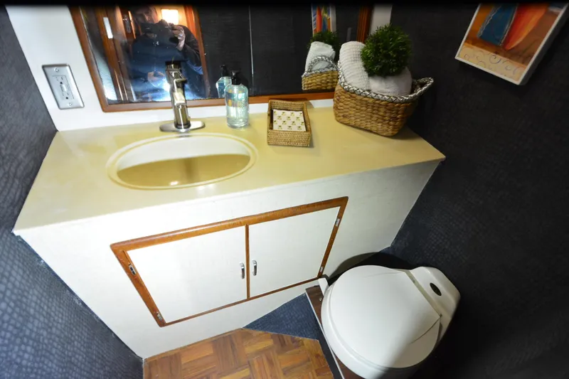 Slide: The Image of Compact bathroom in 1990 Jefferson 52 Marquessa ED yacht with sink, toilet, and decor. - 38