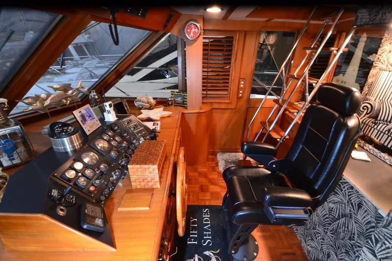 Slide: The Image of 1990 Jefferson 52 Marquessa ED yacht helm with leather chair and wooden dashboard. - 40