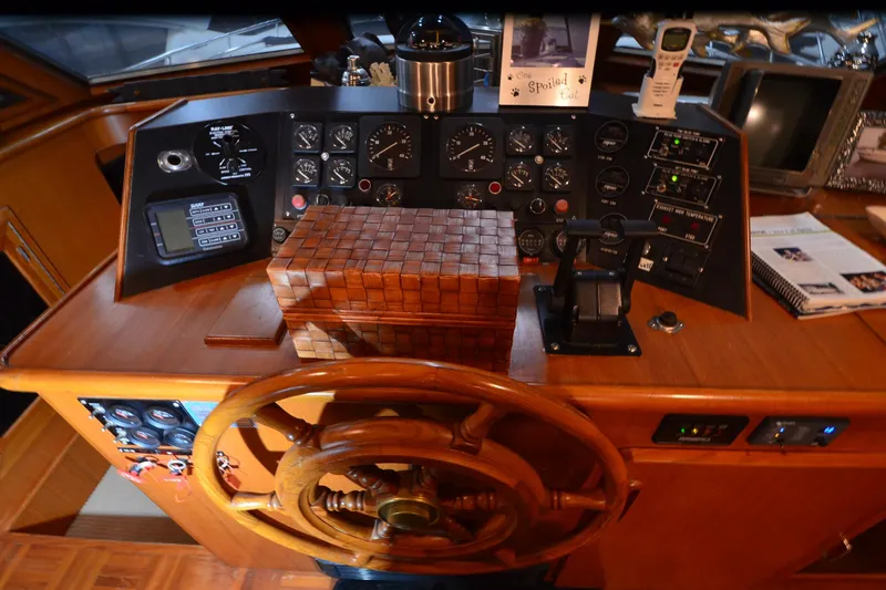 Slide: The Image of 1990 Jefferson 52 Marquessa ED yacht helm with wooden wheel and control panel. - 42