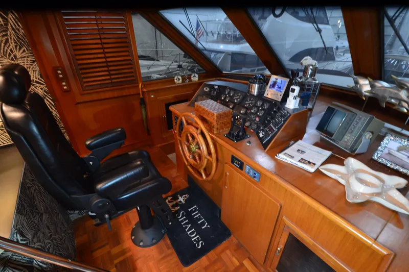 Slide: The Image of Luxurious 1990 Jefferson 52 Marquessa ED yacht helm with leather chair and wooden dashboard. - 43