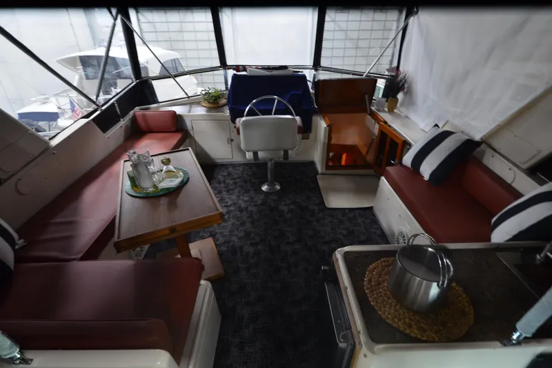 Slide: The Image of Interior of a 1990 Jefferson 52 Marquessa ED yacht with seating and table. - 48